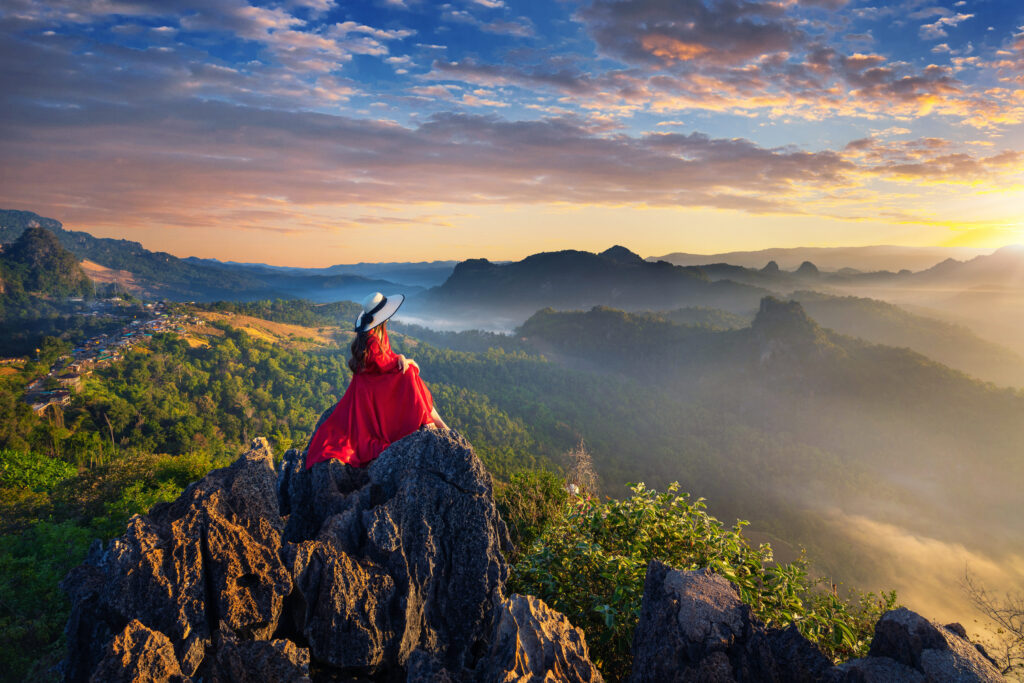beautiful girl sitting on sunrise viewpoint at ja bo village, ma